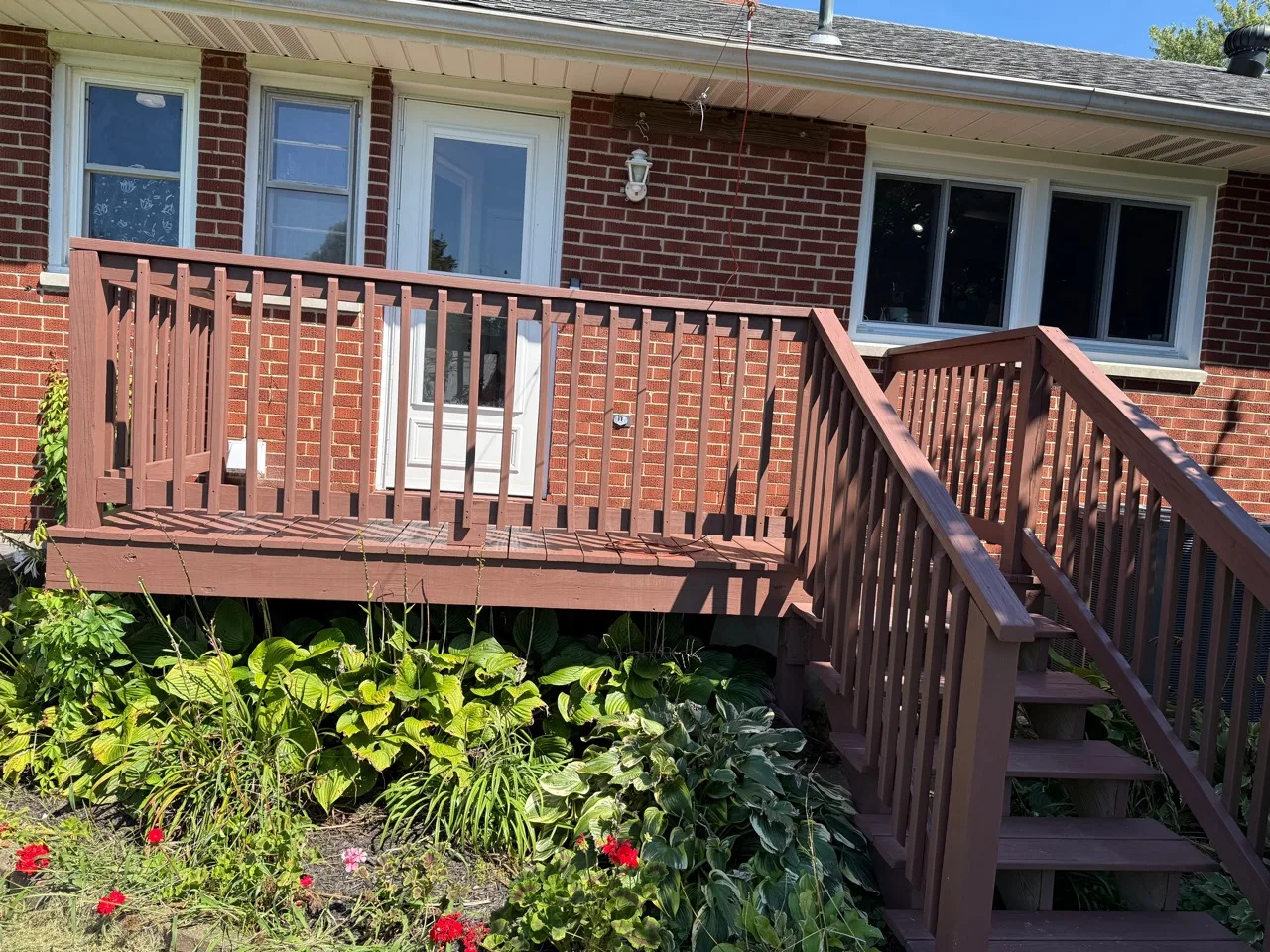Finished deck and railing with an even warm-brown wood finish