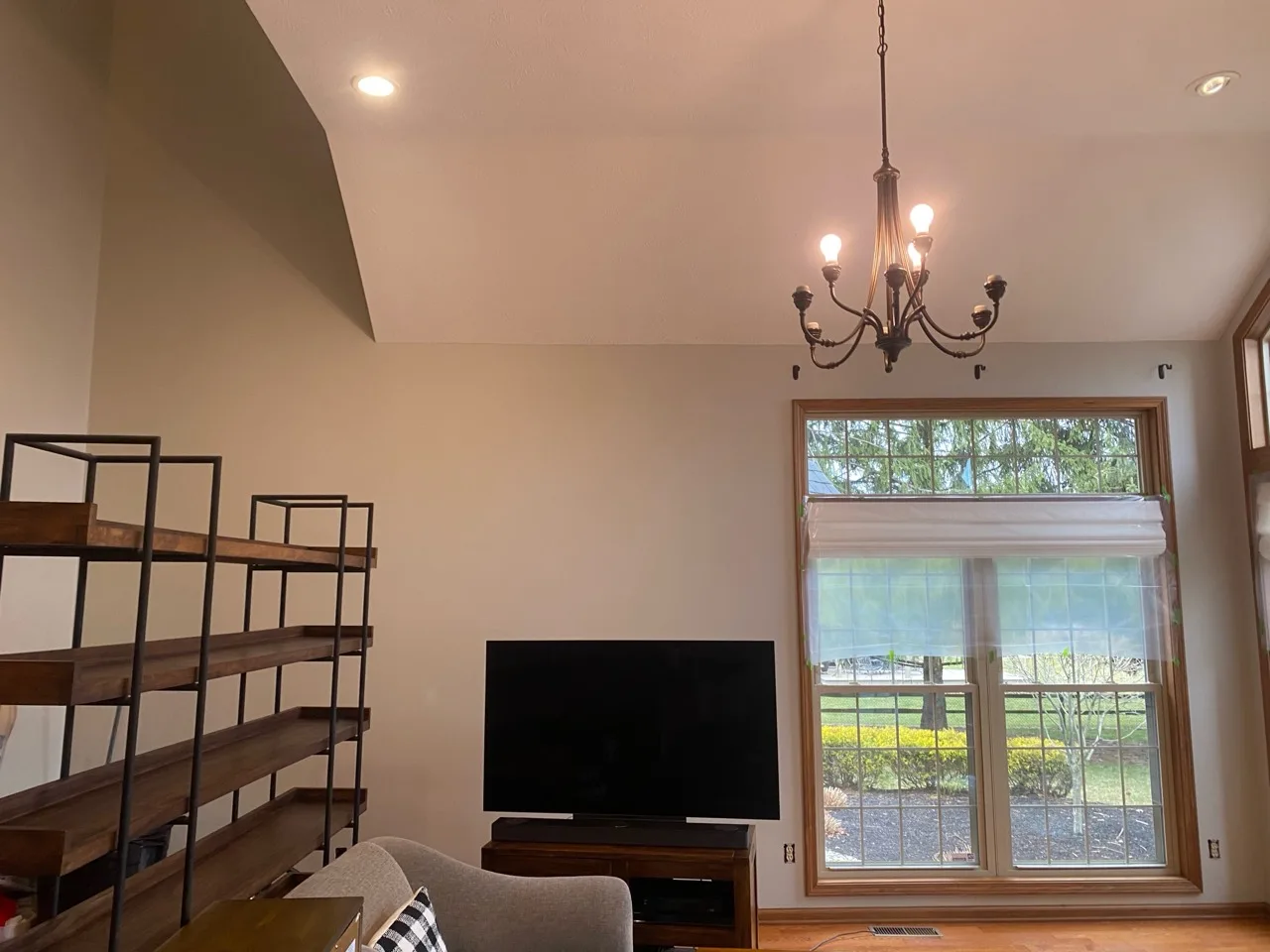 Freshly painted living room walls surrounding a large window and detailed ceiling