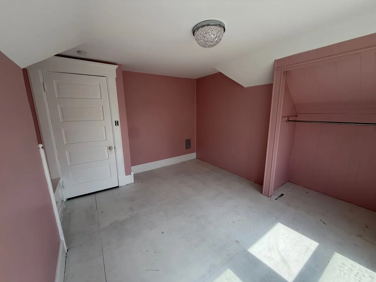 Finished room with evenly painted walls, a paneled feature wall, and crisp white trim