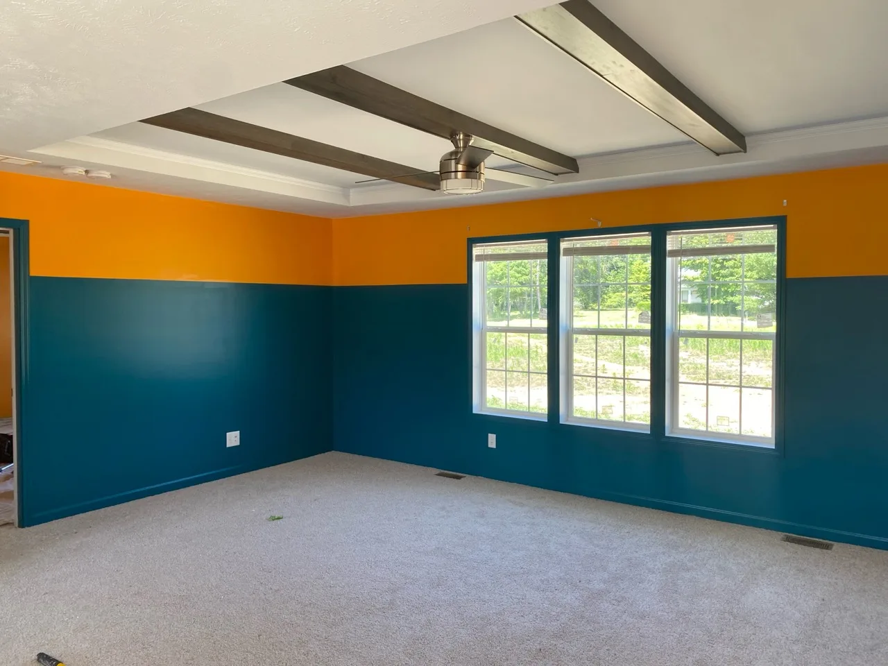 Finished room demonstrating clean two-tone wall lines and careful work around ceiling details