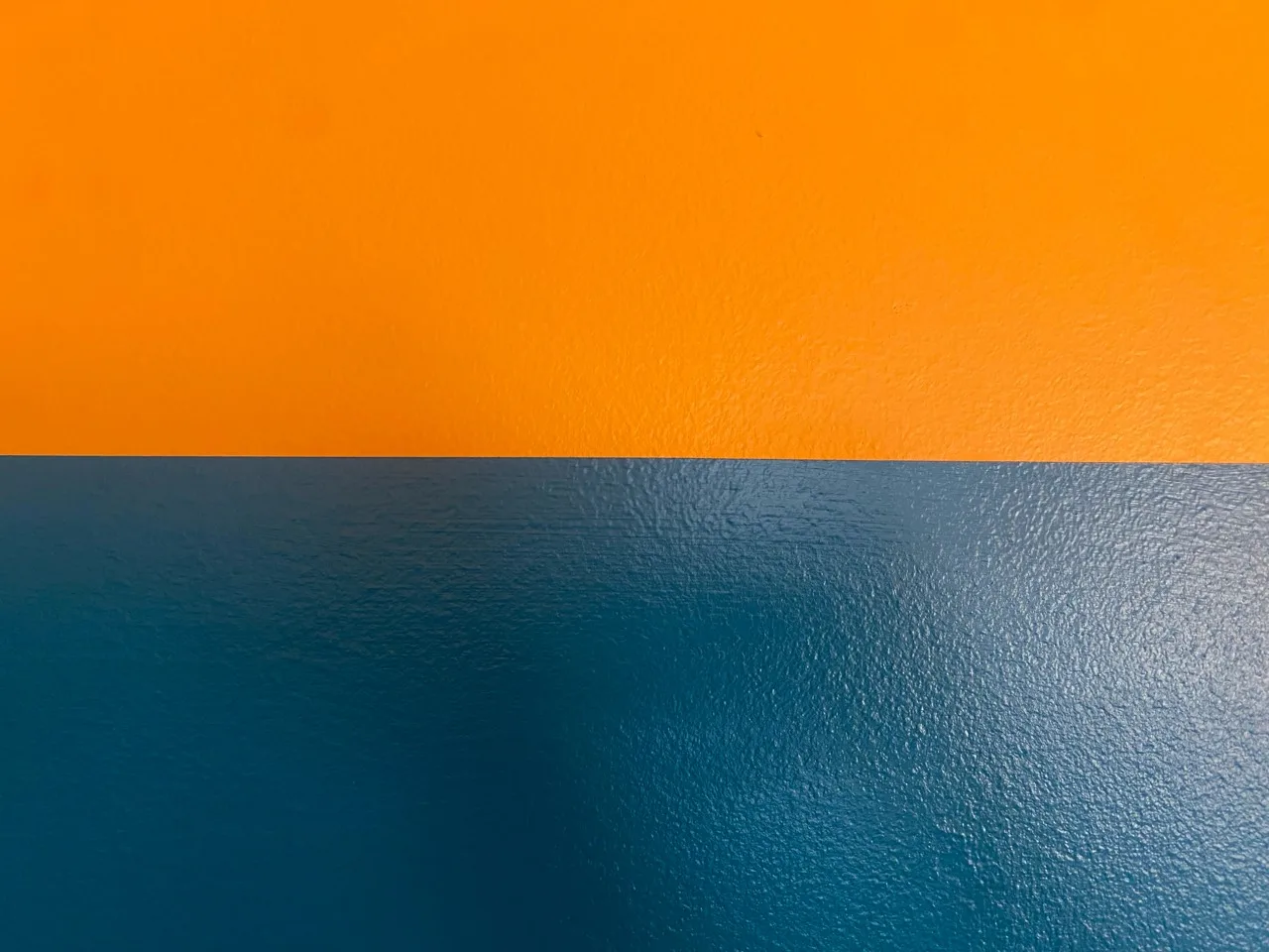Close detail showing a precise horizontal line between two wall colors